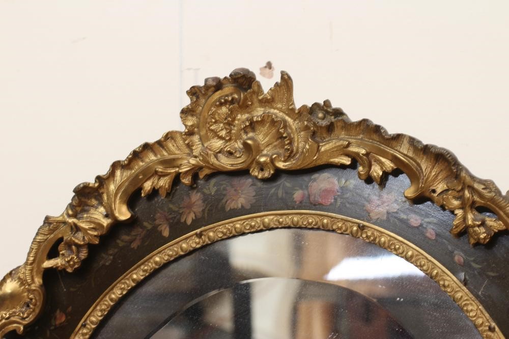A PAINTED AND GILT METAL MOUNTED WALL MIRROR, 20th century, of shield form in the French rococo Image