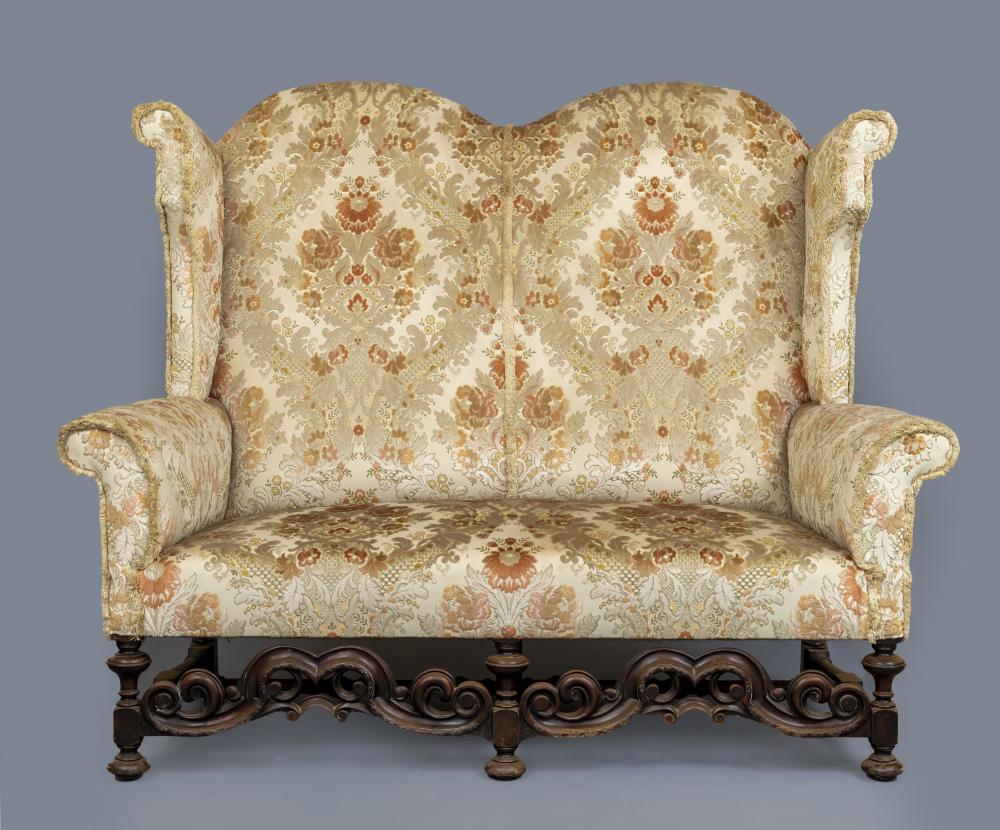 A WILLIAM & MARY STYLE WALNUT FRAMED WING SOFA Image