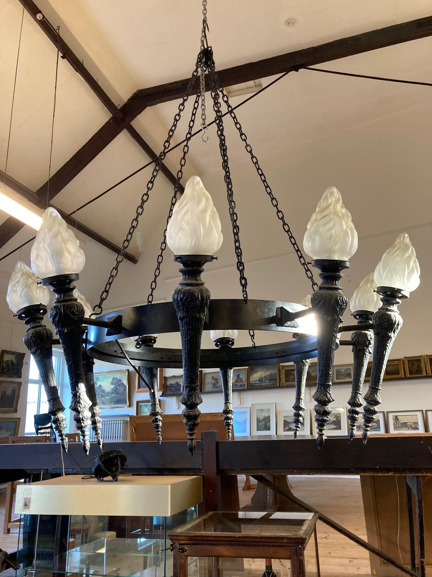 AN EBONISED METAL TEN LIGHT CEILING PENDANT, 20th century, the circlet suspended from chains and Image
