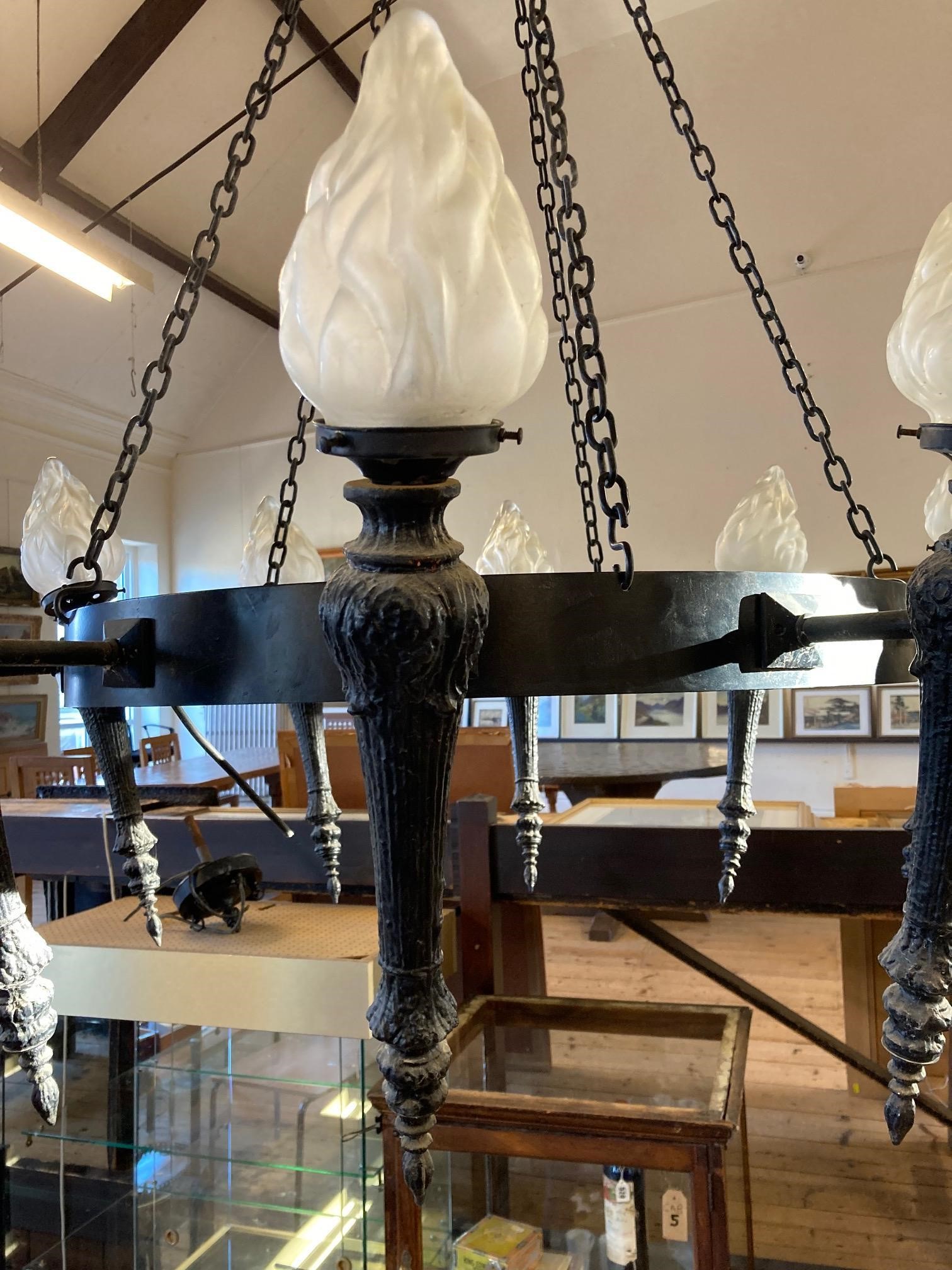 AN EBONISED METAL TEN LIGHT CEILING PENDANT, 20th century, the circlet suspended from chains and Image