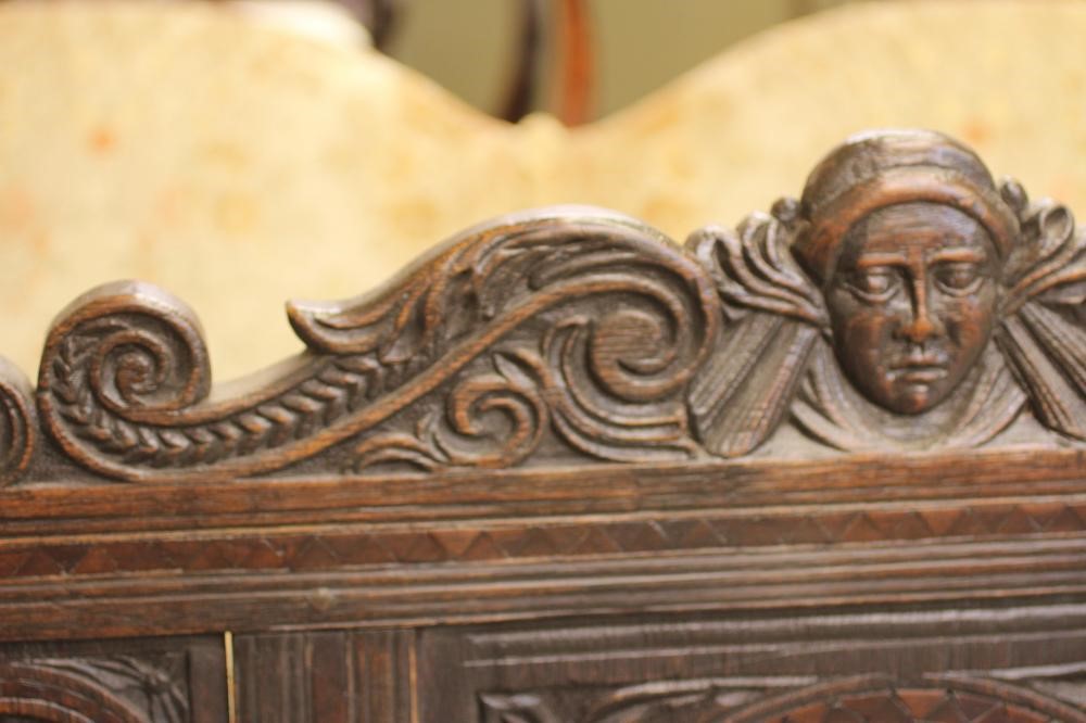 A CARVED OAK SETTLE Image