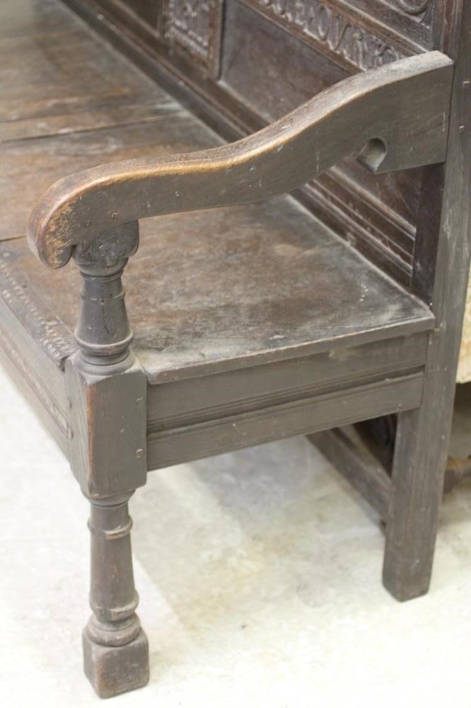 A CARVED OAK SETTLE Image