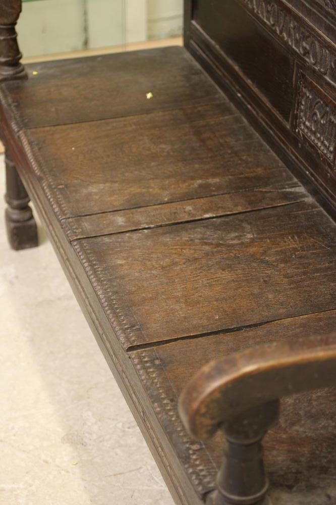 A CARVED OAK SETTLE Image
