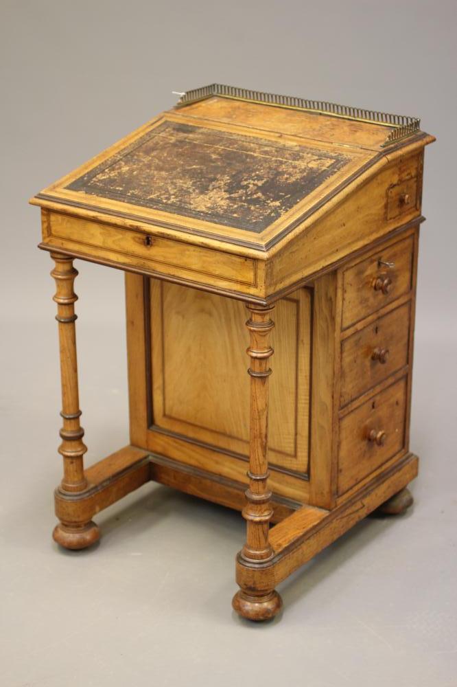 AN ASH AND ROSEWOOD BANDED DAVENPORT BY GILLOW Image