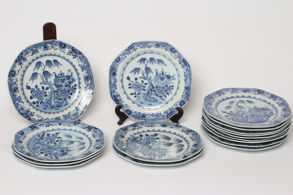 A SET OF SIXTEEN CHINESE PORCELAIN OCTAGONAL PLATES painted in underglaze blue with vases on a table Image