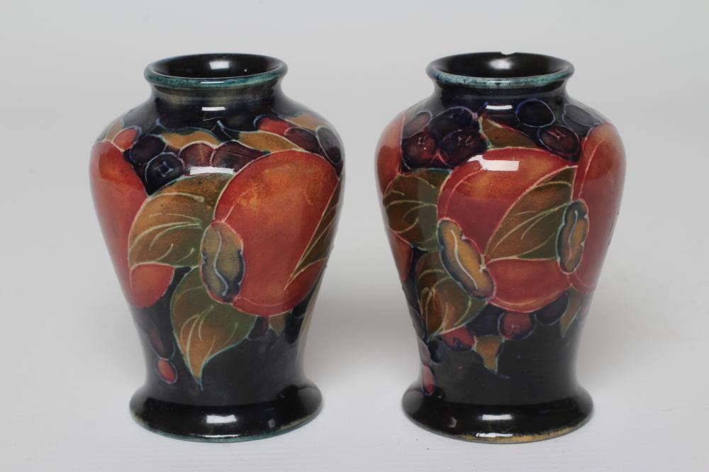 A PAIR OF MOORCROFT POTTERY POMEGRANATE SMALL VASES, c.1915, of inverted baluster form, initialled Image