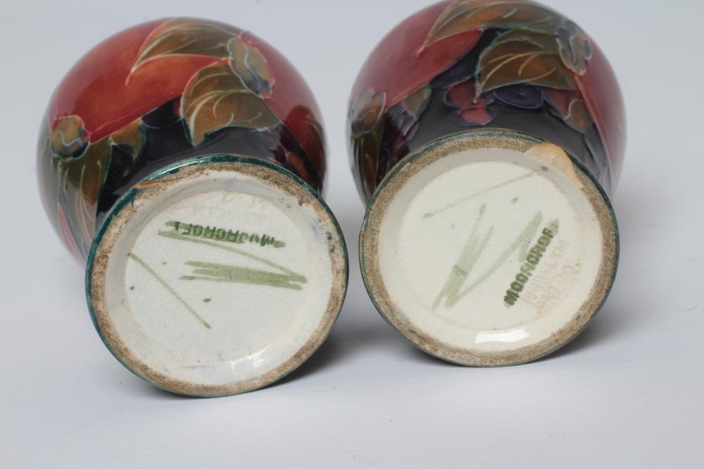 A PAIR OF MOORCROFT POTTERY POMEGRANATE SMALL VASES, c.1915, of inverted baluster form, initialled Image