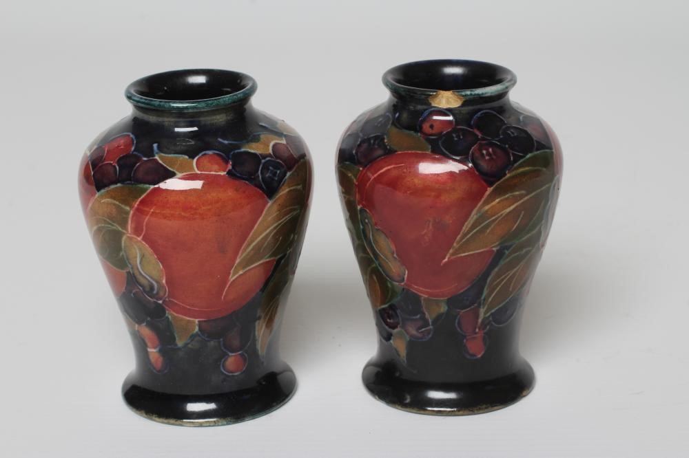 A PAIR OF MOORCROFT POTTERY POMEGRANATE SMALL VASES, c.1915, of inverted baluster form, initialled Image