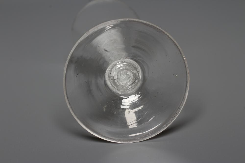 A LATE GEORGIAN CORDIAL GLASS, the rounded bucket bowl issuing from an opaque multi-ply central Image