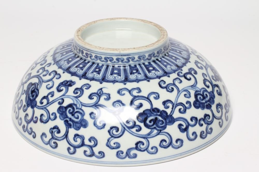 A CHINESE PORCELAIN SHALLOW BOWL of plain circular form, the exterior painted in underglaze blue Image