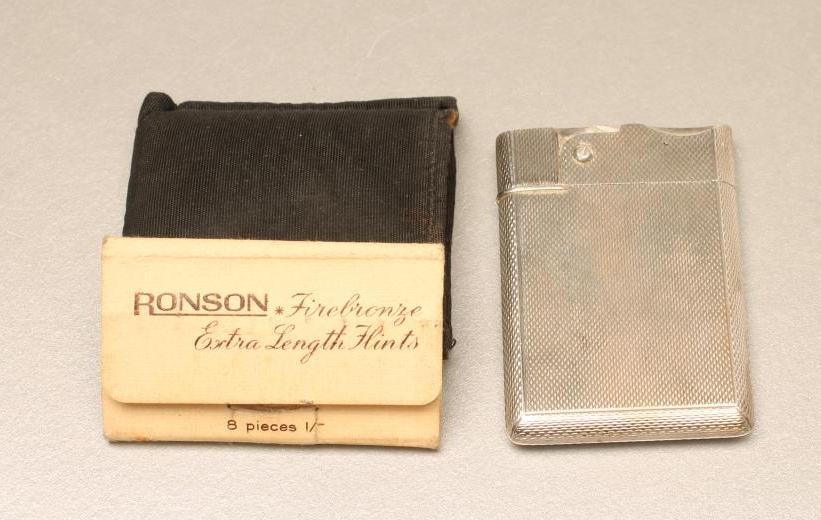 A SILVER CIGARETTE LIGHTER Image