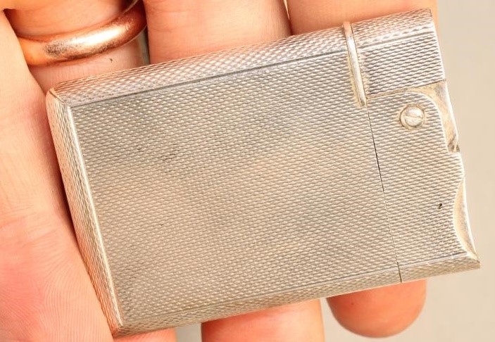 A SILVER CIGARETTE LIGHTER Image