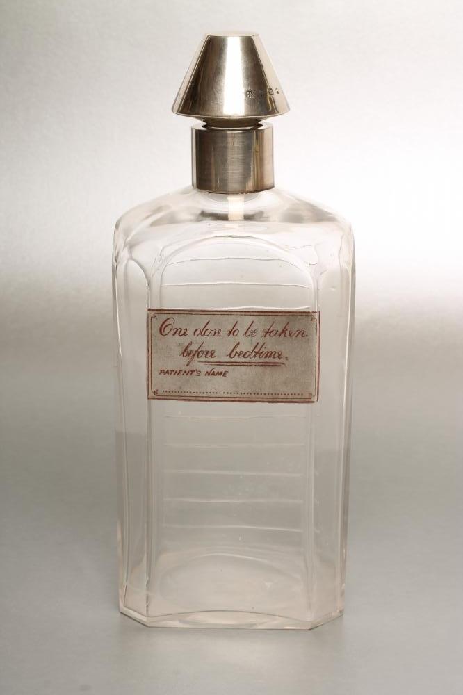 A LATE VICTORIAN SILVER MOUNTED GLASS NOVELTY SPIRIT DECANTER Image