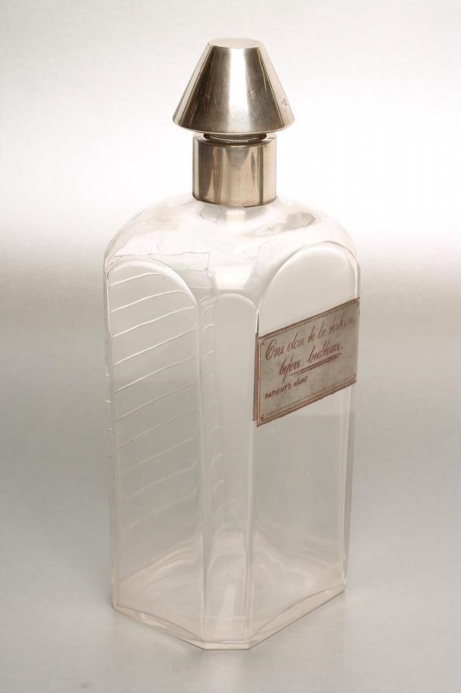 A LATE VICTORIAN SILVER MOUNTED GLASS NOVELTY SPIRIT DECANTER Image