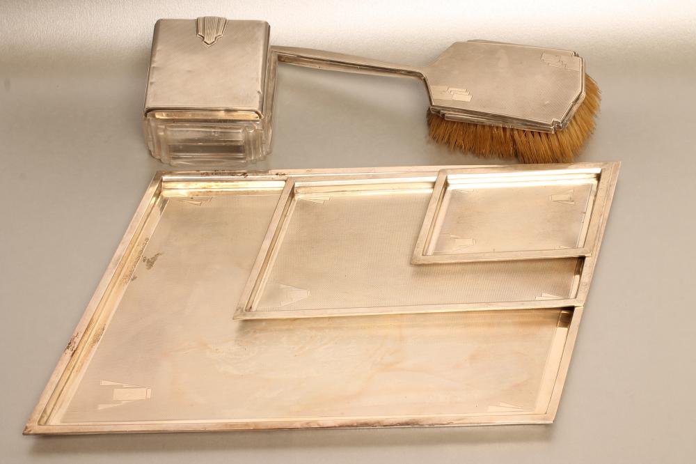 A COMPOSITE FIVE PIECE ART DECO SILVER DRESSING TABLE SET Image