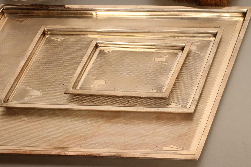 A COMPOSITE FIVE PIECE ART DECO SILVER DRESSING TABLE SET Image