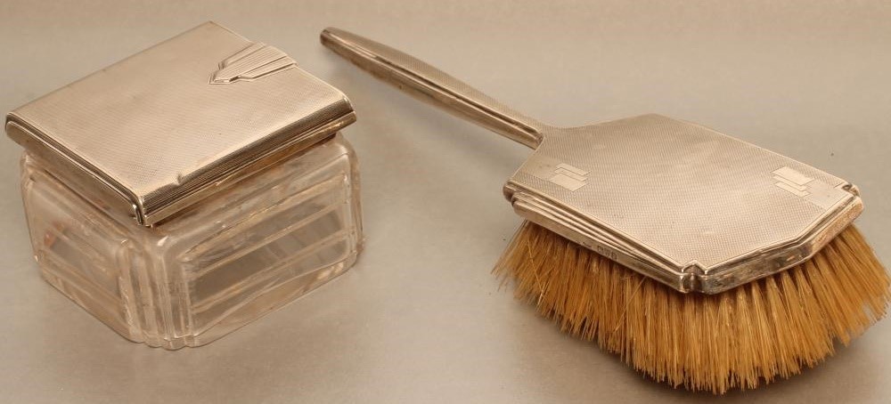 A COMPOSITE FIVE PIECE ART DECO SILVER DRESSING TABLE SET Image