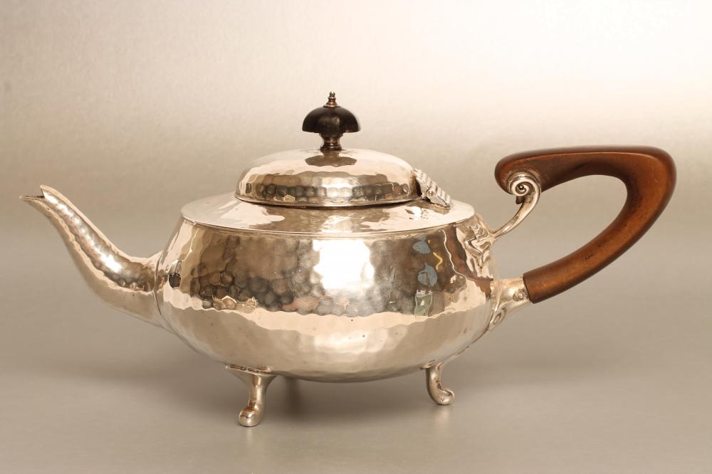 AN ARTS AND CRAFTS SILVER TEAPOT Image