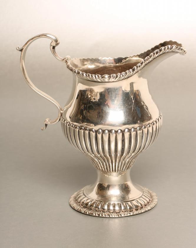 A GEORGE III SILVER MILK JUG Image