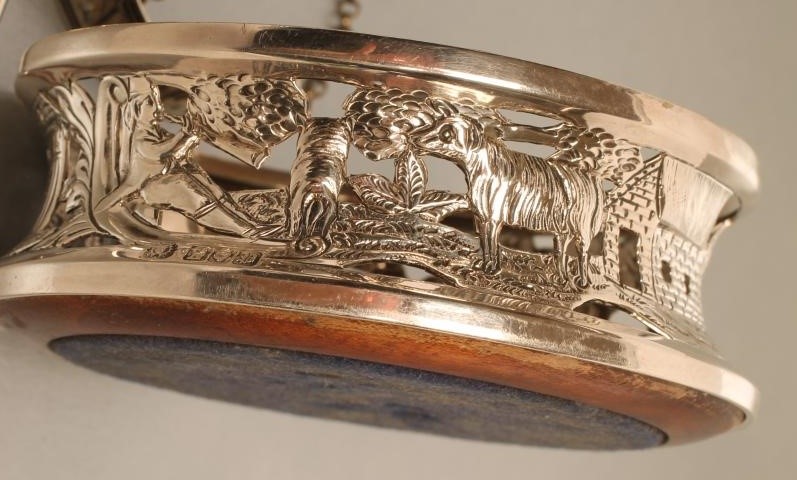 AN EDWARDIAN IRISH SILVER BOTTLE COASTER Image