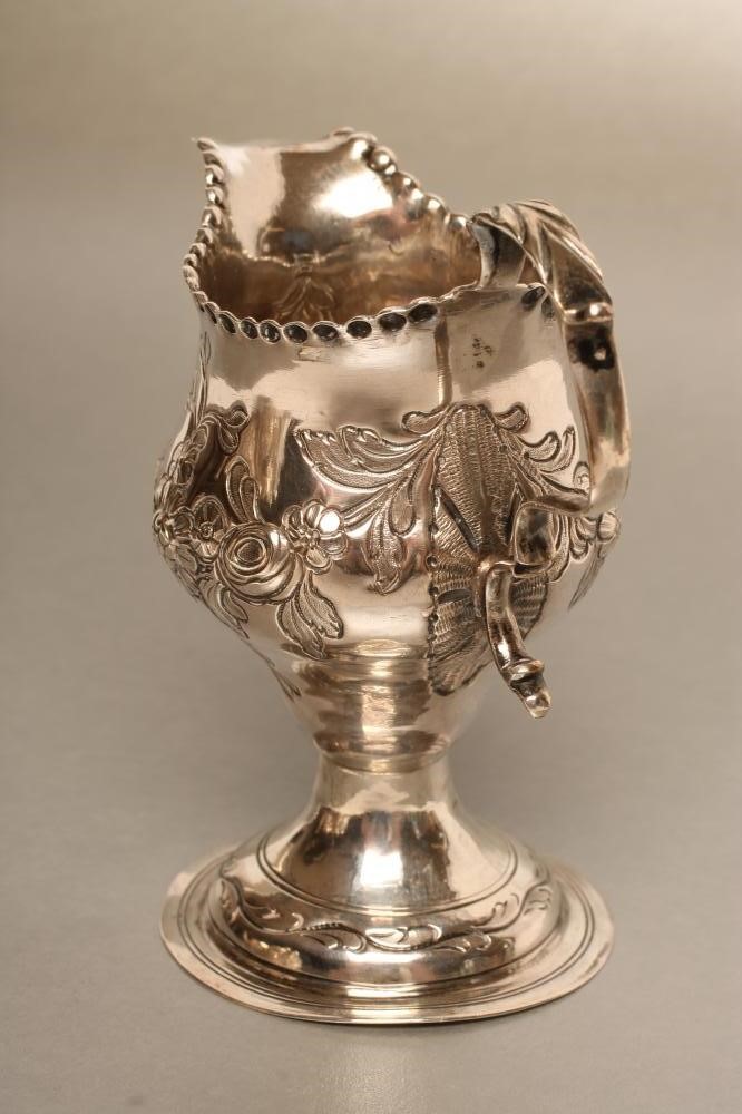 A GEORGE III SILVER CREAM JUG Image