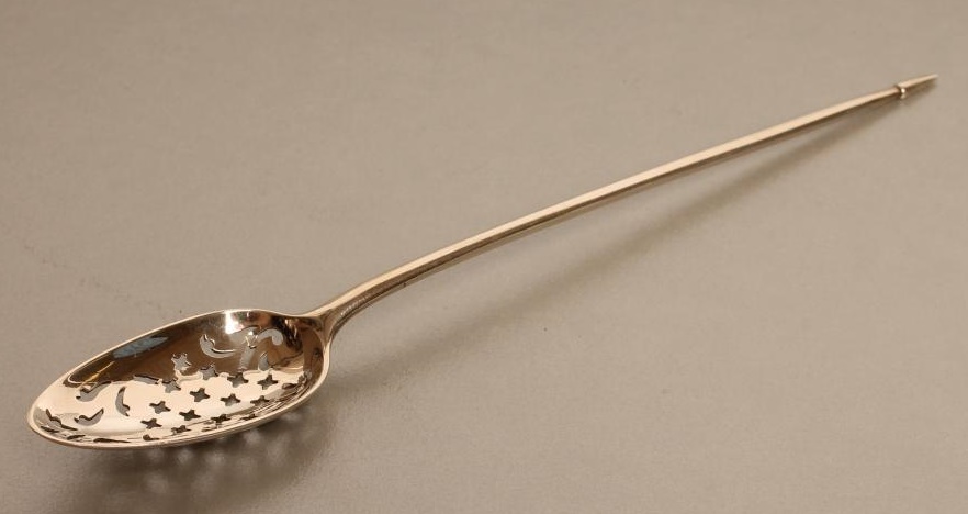 A LATE GEORGE III SILVER MOTE SPOON Image