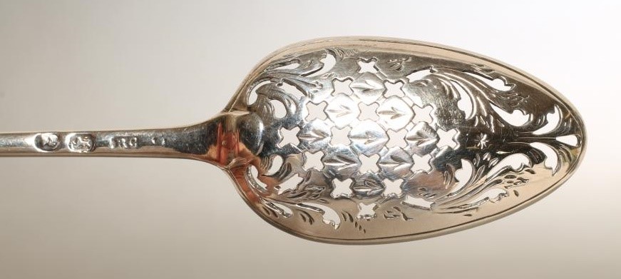 A LATE GEORGE III SILVER MOTE SPOON Image