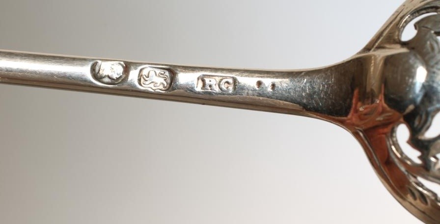 A LATE GEORGE III SILVER MOTE SPOON Image