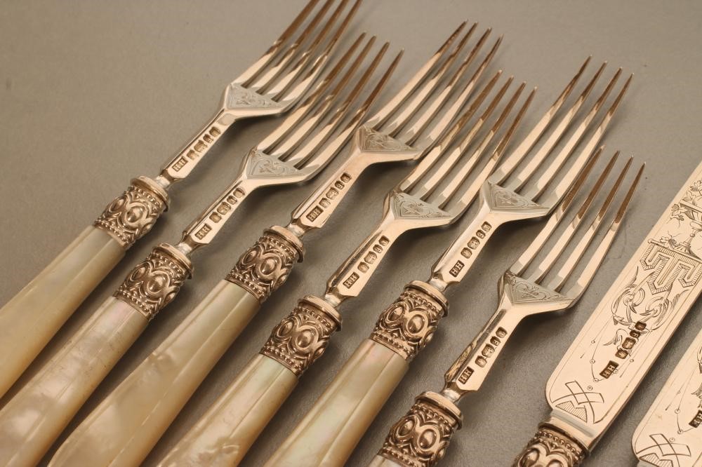 A SET OF SIX PAIRS OF VICTORIAN SILVER DESSERT KNIVES AND FORKS Image