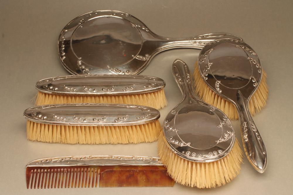 A COMPOSITE EDWARDIAN ART NOUVEAU SILVER SIX PIECE DRESSING TABLE SET Image