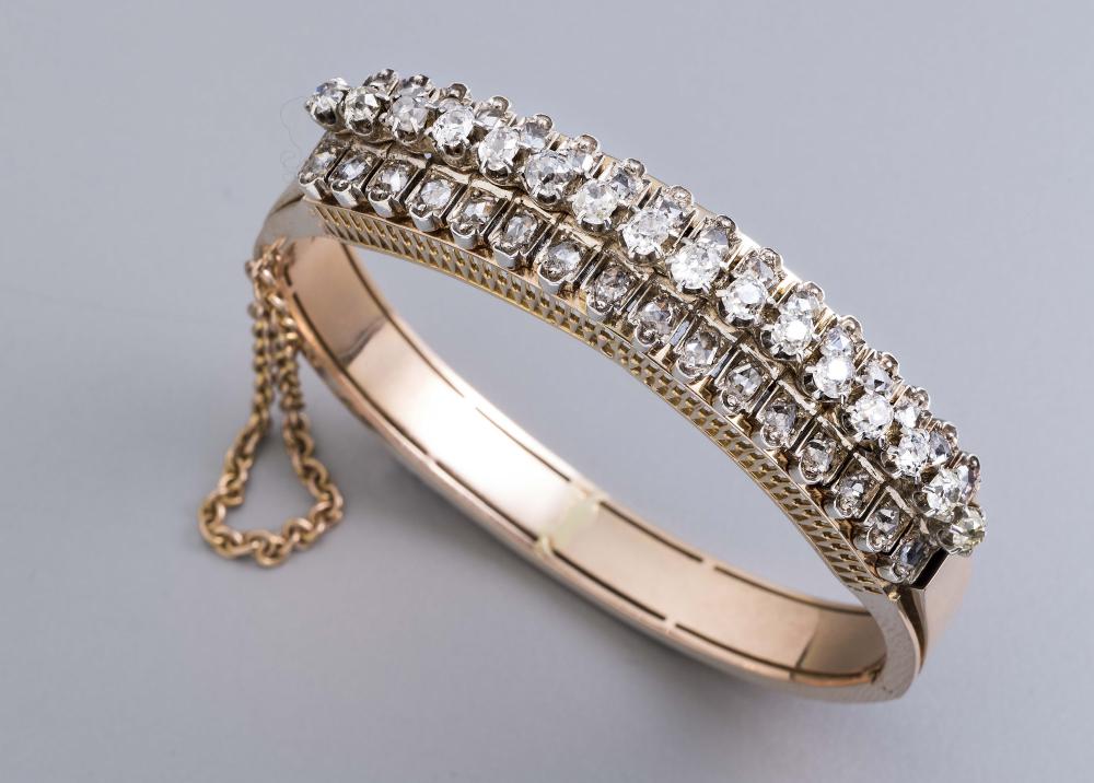 A DIAMOND STIFF HINGED BANGLE Image