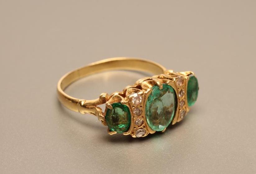 A THREE STONE EMERALD RING Image
