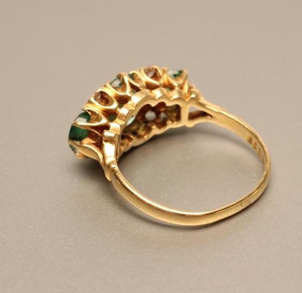 A THREE STONE EMERALD RING Image