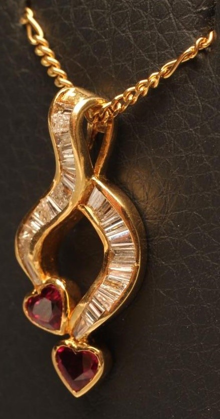 A DIAMOND AND RUBY PENDANT of open abstract form Image
