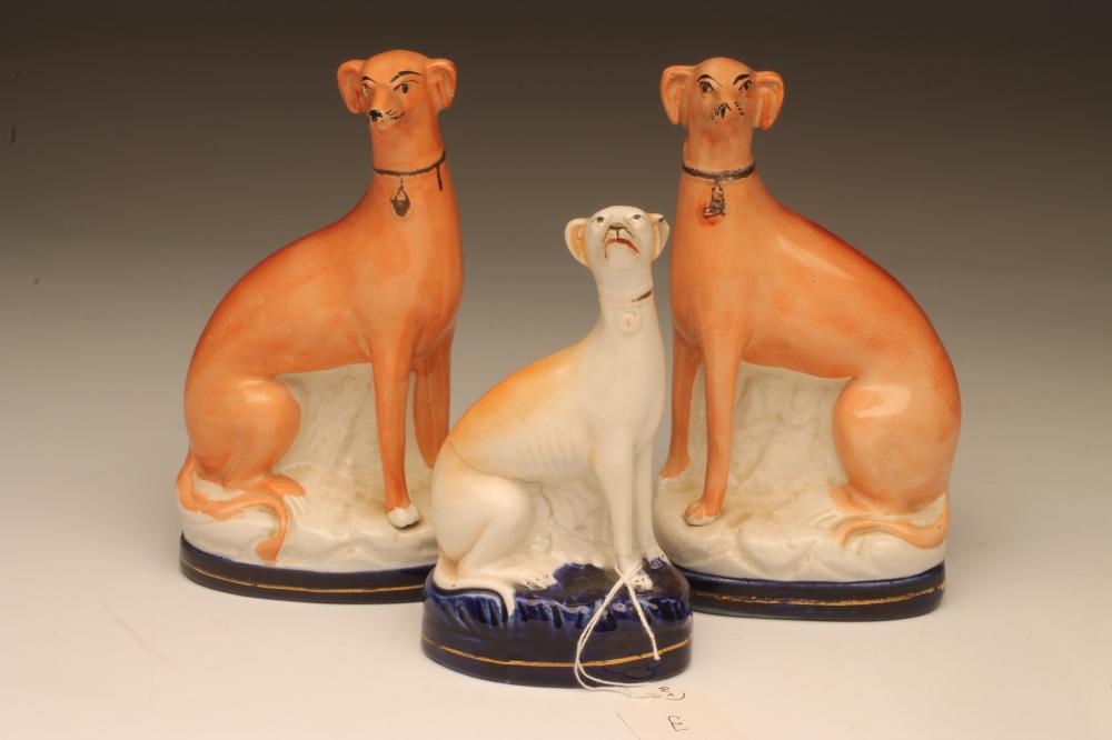A PAIR OF VICTORIAN STAFFORDSHIRE POTTERY GREYHOUNDS Image