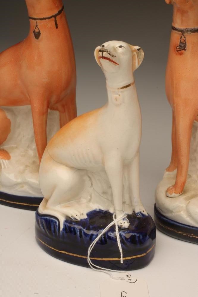 A PAIR OF VICTORIAN STAFFORDSHIRE POTTERY GREYHOUNDS Image