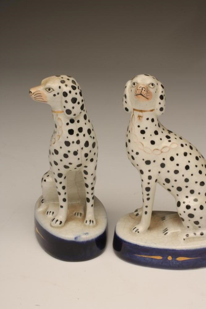 A PAIR OF LATE VICTORIAN STAFFORDSHIRE POTTERY DALMATIONS Image