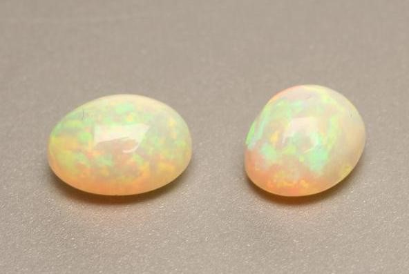 TWO CABOCHON POLISHED OPALS Image