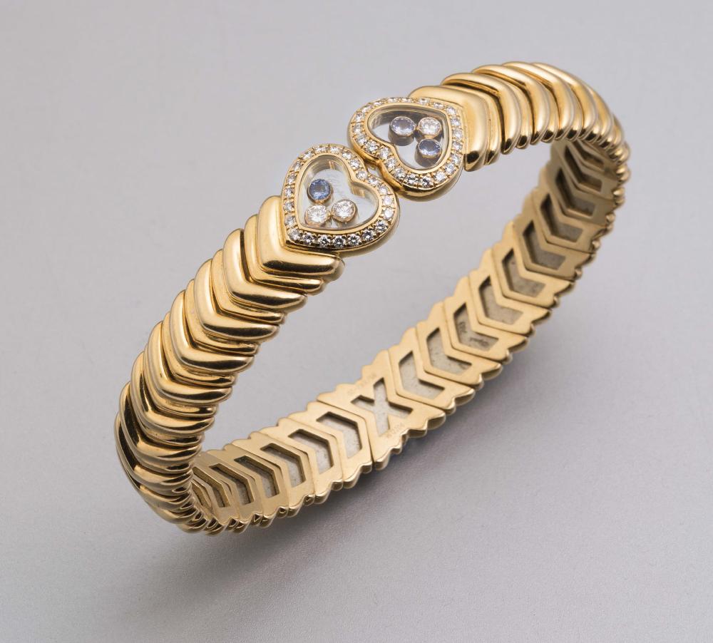 A CHOPARD 18CT GOLD AND DIAMOND BANGLE Image