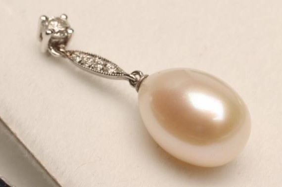 A PAIR OF PEARL AND DIAMOND DROP EAR STUDS Image