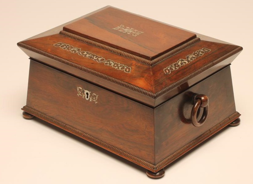 A VICTORIAN ROSEWOOD WORK BOX of sarcophagus form with reed edging and inlaid mother of pearl Image