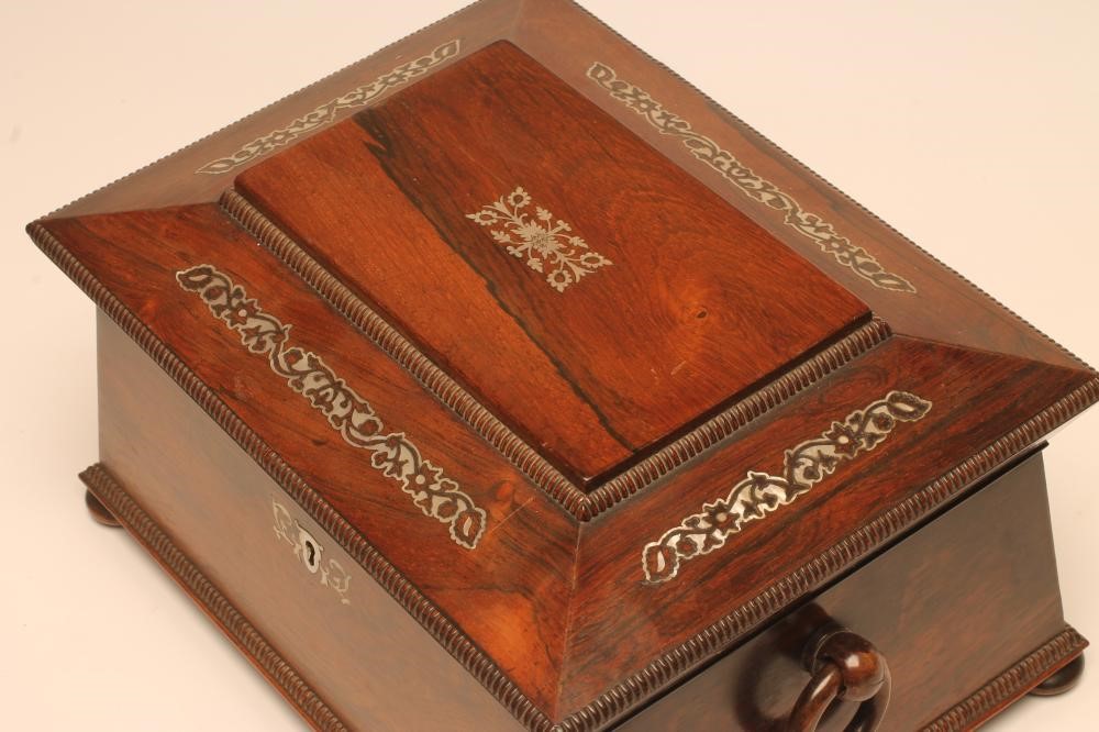 A VICTORIAN ROSEWOOD WORK BOX of sarcophagus form with reed edging and inlaid mother of pearl Image