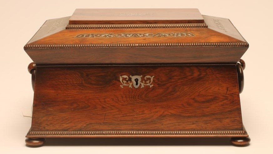 A VICTORIAN ROSEWOOD WORK BOX of sarcophagus form with reed edging and inlaid mother of pearl Image