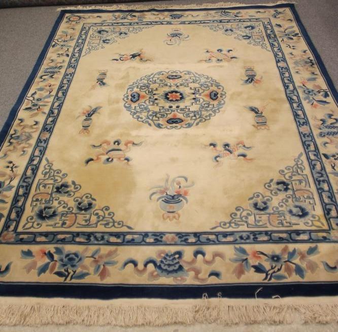 A CHINESE WASHED AND FRINGED WOOL RUG Image