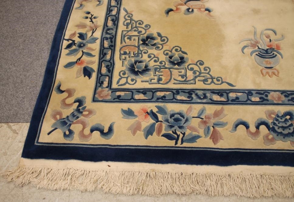 A CHINESE WASHED AND FRINGED WOOL RUG Image