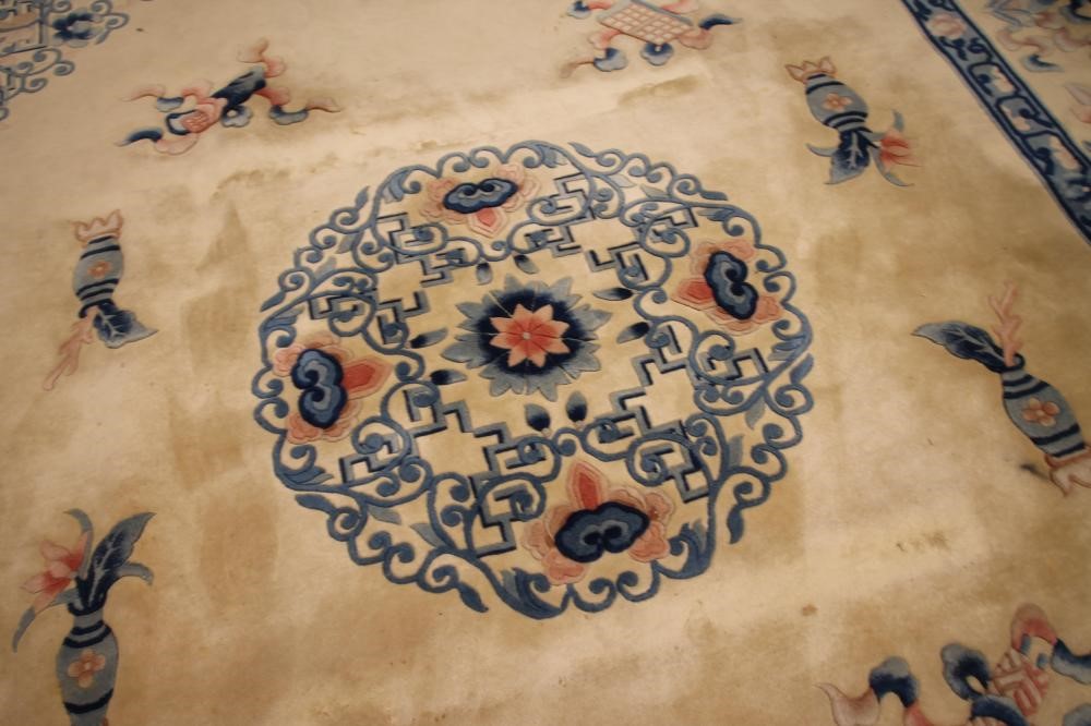 A CHINESE WASHED AND FRINGED WOOL RUG Image