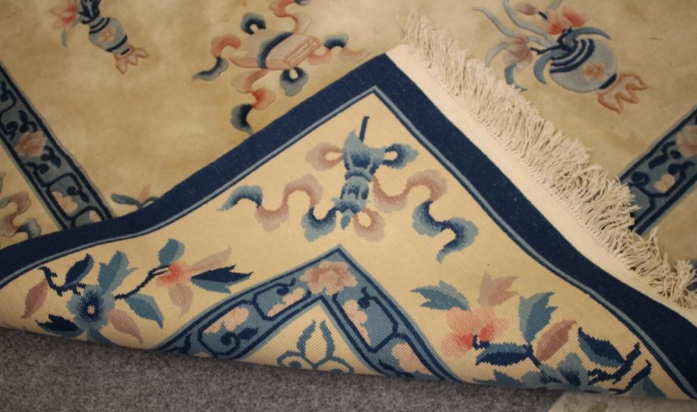 A CHINESE WASHED AND FRINGED WOOL RUG Image