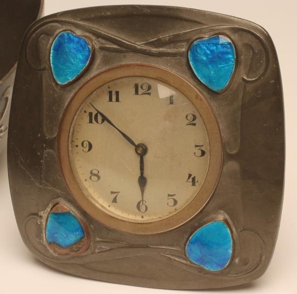 A TUDRIC PEWTER AND ENAMEL DESK CLOCK Image
