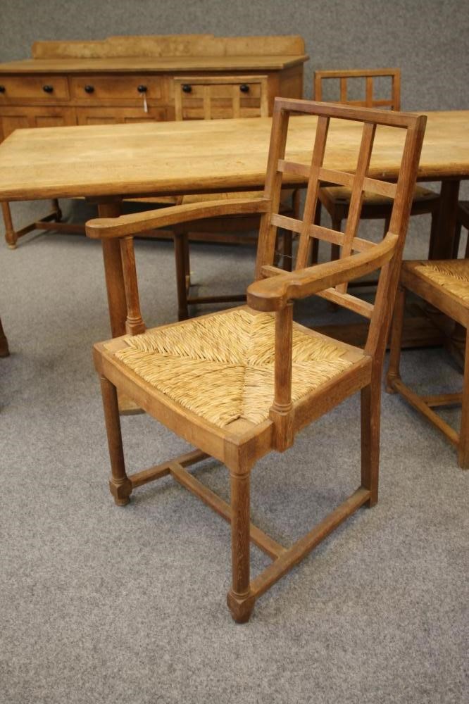 AN ARTS AND CRAFTS STYLE OAK DINING SUITE by Heals of London Image