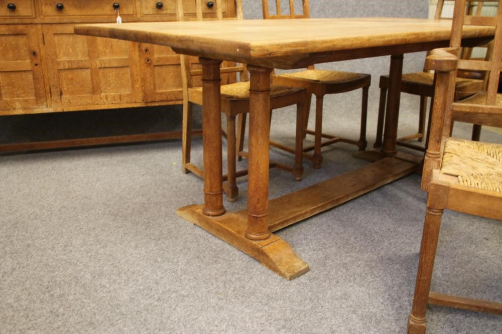 AN ARTS AND CRAFTS STYLE OAK DINING SUITE by Heals of London Image